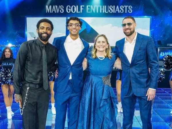 Kyrie Irving, Klay Thompson, and Max Christie with a lucky fan. | Photo courtesy of Mavs Ball