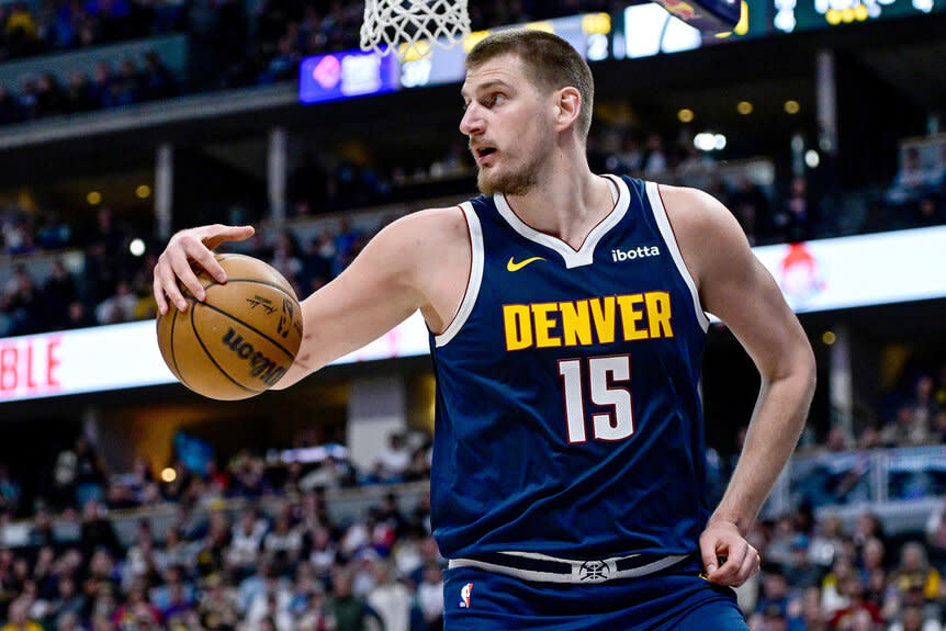 Nikola Jokic of the Denver Nuggets collects a loose ball at a basketball game against the Utah jazz