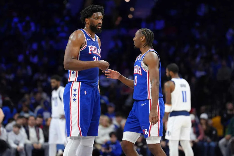 Feb 4, 2025; Philadelphia, Pennsylvania, USA; Philadelphia 76ers center Joel Embiid (21) reacts with guard Tyrese Maxey (0) against the Dallas Mavericks in the second quarter at Wells Fargo Center. Mandatory Credit: Kyle Ross-Imagn Images
