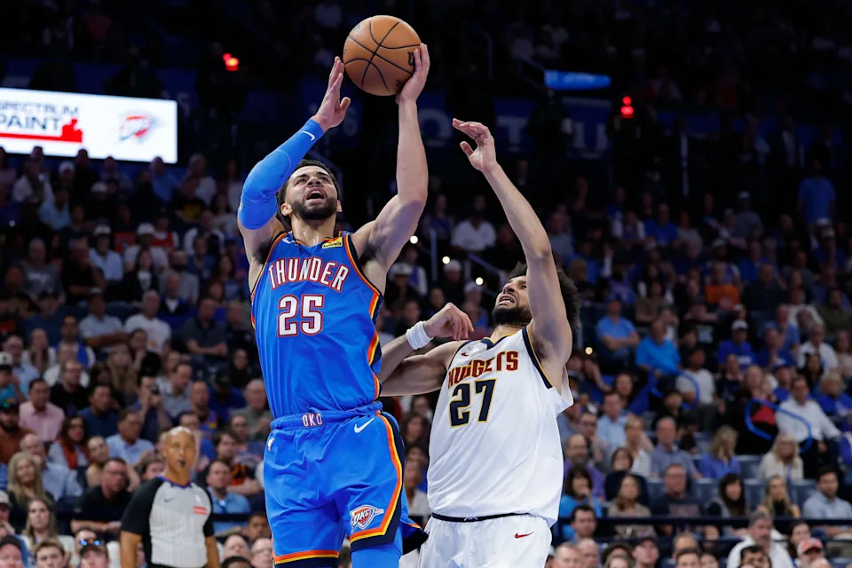 Mar 9, 2026; Oklahoma City, Oklahoma, USA; Oklahoma City Thunder guard Ajay Mitchell (25) goes up for a basket beside Denver Nuggets guard Jamal Murray (27) during the second half at Paycom Center. Mandatory Credit: Alonzo Adams-Imagn Images