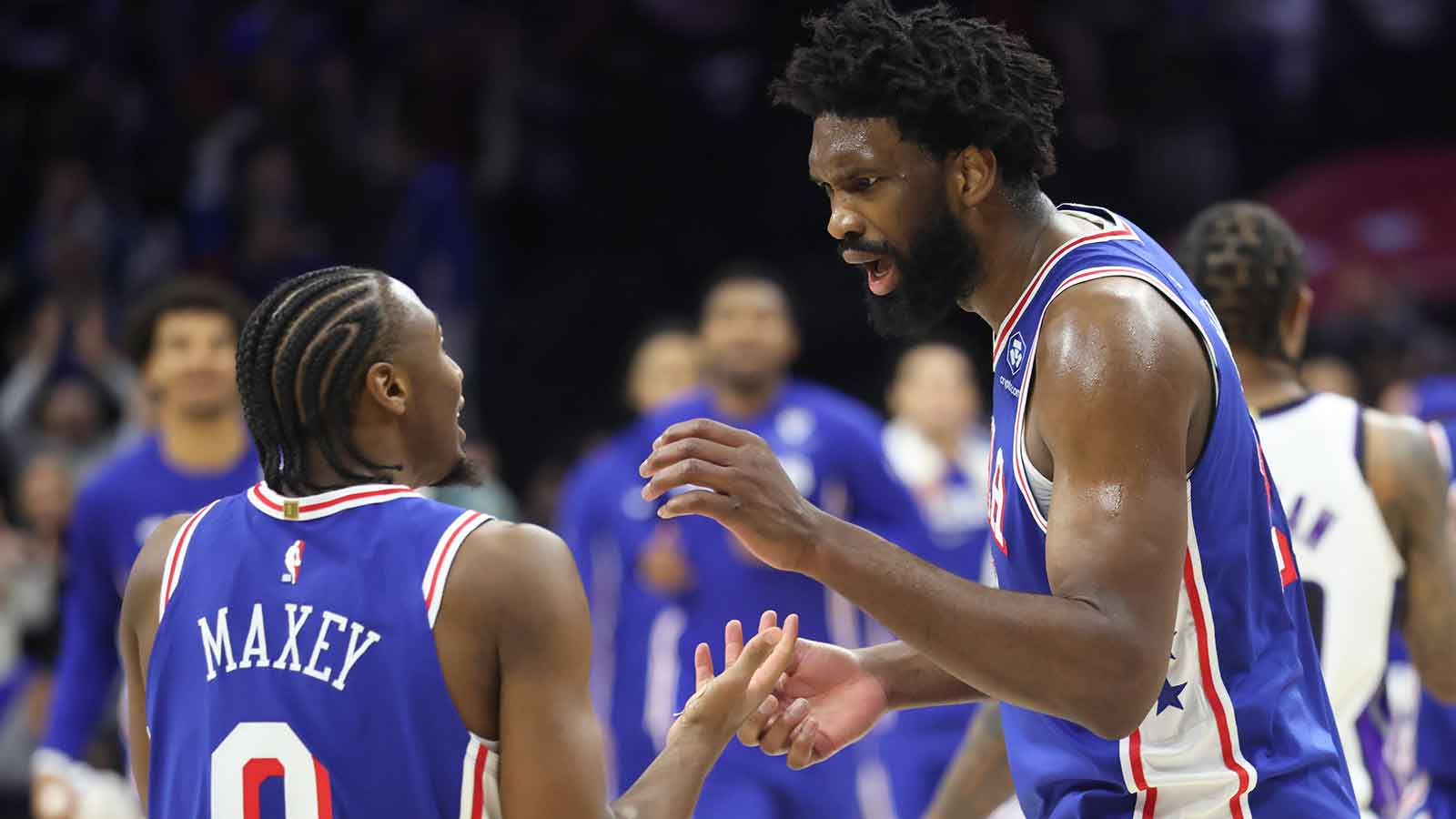 76ers center Joel Embiid talks to Tyrese Maxey