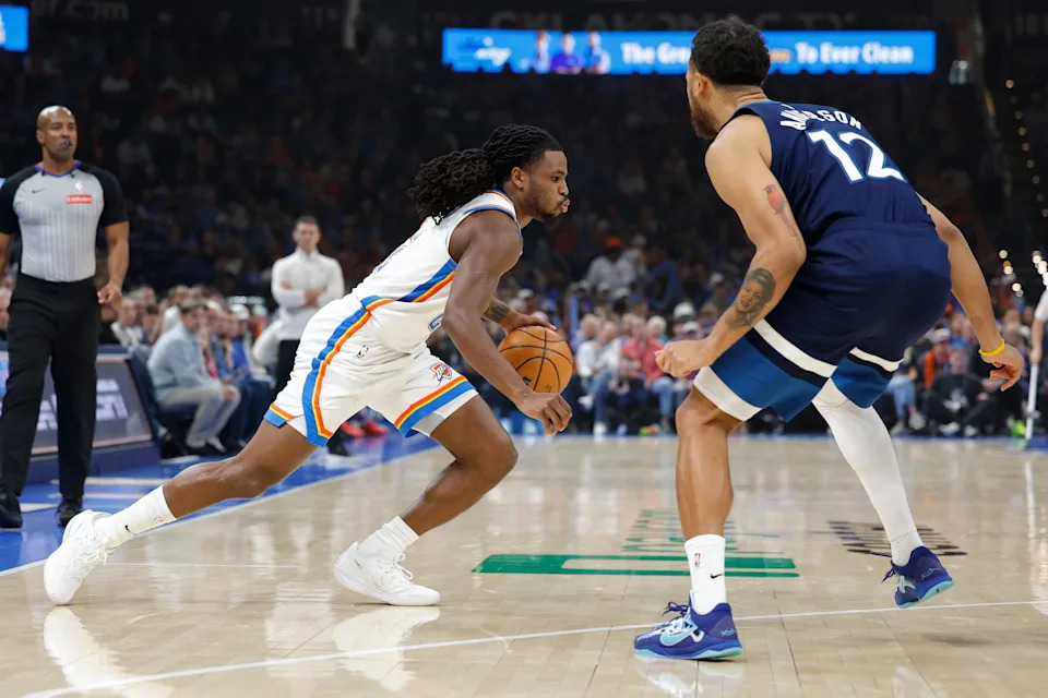 Mar 15, 2026; Oklahoma City, Oklahoma, USA; Oklahoma City Thunder guard Cason Wallace (22) drives around Minnesota Timberwolves forward/guard Kyle Anderson (12) during the first half at Paycom Center. Mandatory Credit: Alonzo Adams-Imagn Images