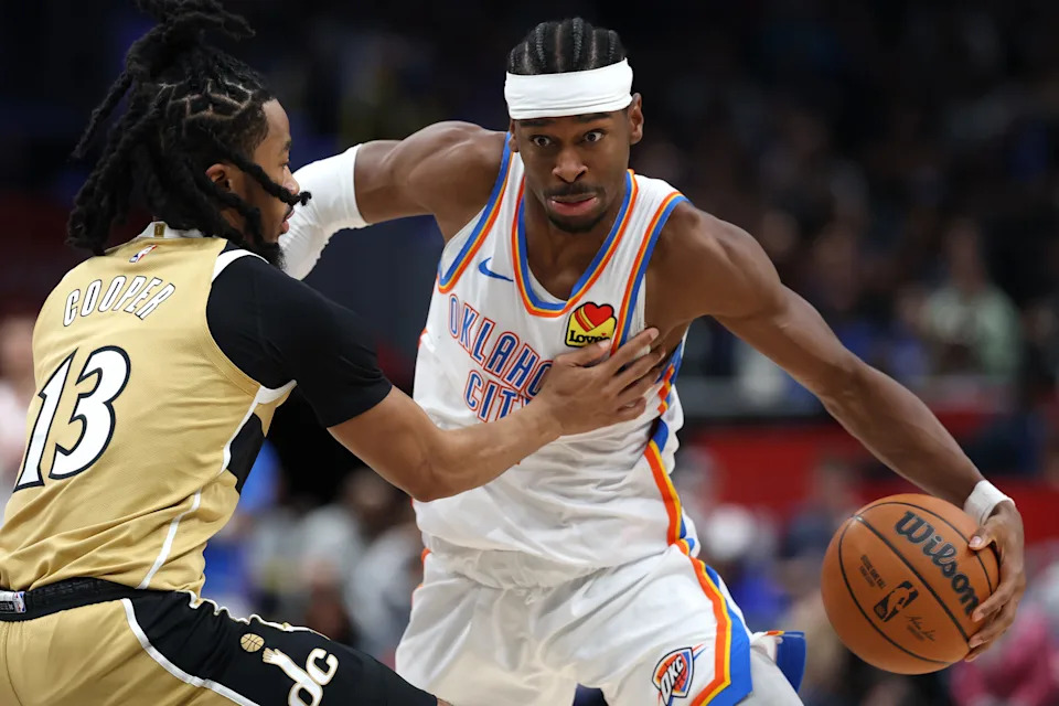 WASHINGTON, DC - MARCH 21: Shai Gilgeous-Alexander #2 of the Oklahoma City Thunder dribbles past Sharife Cooper #13 of the Washington Wizards during the first half at Capital One Arena on March 21, 2026 in Washington, DC. NOTE TO USER: User expressly acknowledges and agrees that, by downloading and or using this photograph, User is consenting to the terms and conditions of the Getty Images License Agreement. (Photo by Patrick Smith/Getty Images)