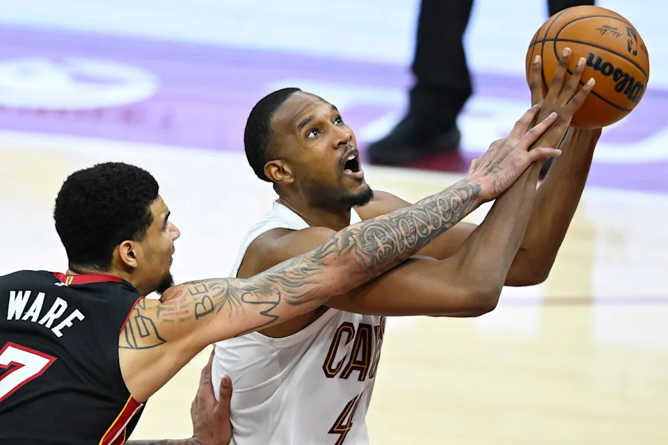 Mar 25, 2026; Cleveland, Ohio, USA; Miami Heat center Kel'el Ware (7) defends a shot by Cleveland Cavaliers center Evan Mobley (4) in the fourth quarter at Rocket Arena. Mandatory Credit: David Richard-Imagn Images