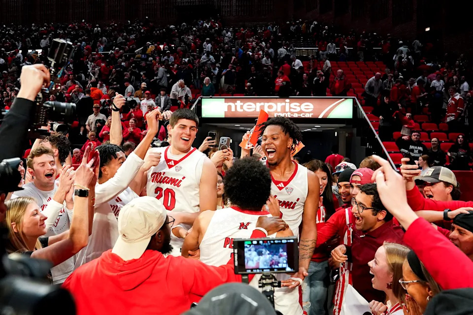Miami RedHawks players celebrate with fans after defeating the Toledo Rockets at Millett Hall