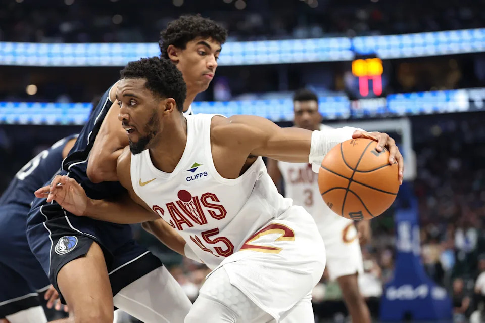 Cleveland Cavaliers guard Donovan Mitchell (45) drives to the basket as Dallas Mavericks guard Max Christie (00) defends March 13, 2026, in Dallas, Texas.