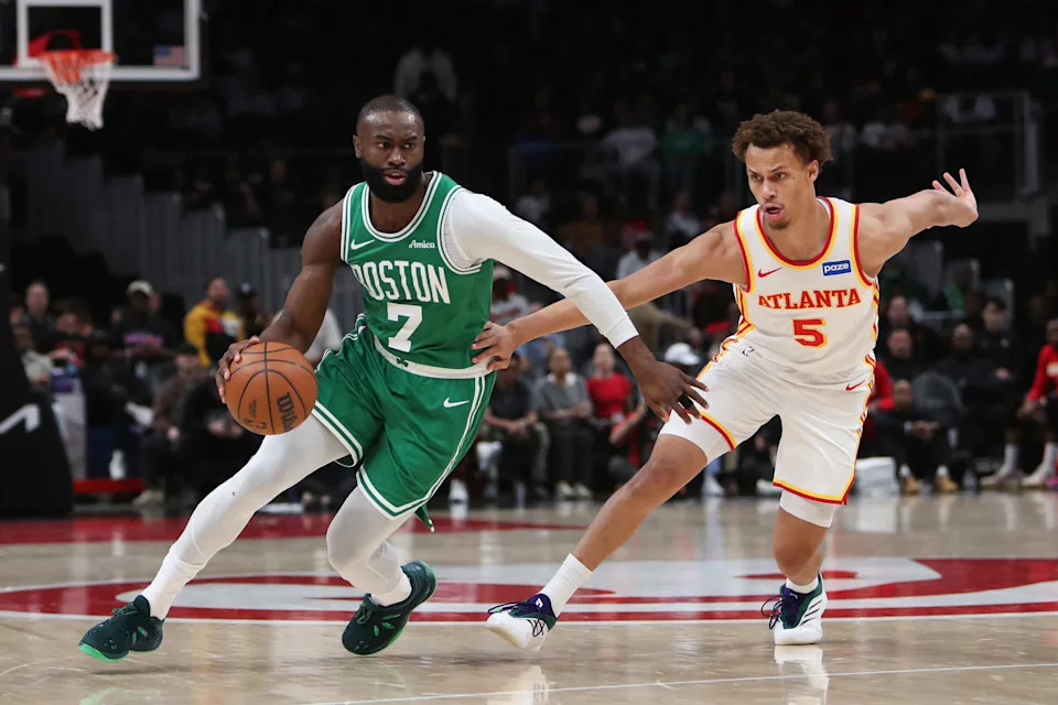 Mar 30, 2026; Atlanta, Georgia, USA; Boston Celtics guard Jaylen Brown (7) dribbles against Atlanta Hawks guard Dyson Daniels (5) in the first half at State Farm Arena. Mandatory Credit: Mady Mertens-Imagn Images
