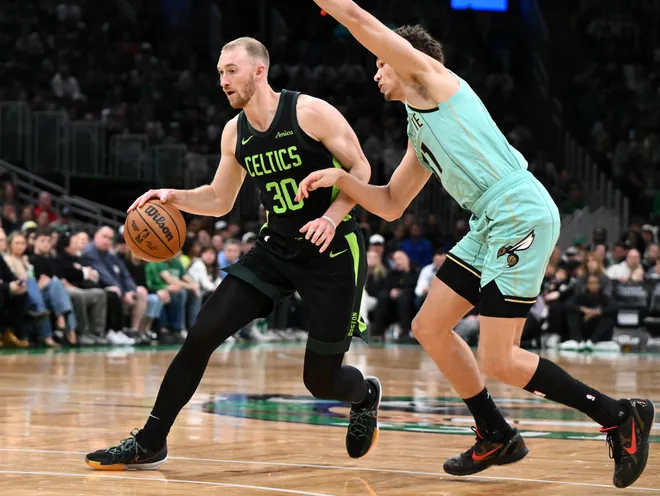 BOSTON, MASSACHUSETTS - APRIL 13: Sam Hauser #30 of the Boston Celtics drives to the basket against Tidjane Salaun #31 of the Charlotte Hornets during first half at the TD Garden on April 13, 2025 in Boston, Massachusetts. NOTE TO USER: User expressly acknowledges and agrees that, by downloading and or using this photograph, User is consenting to the terms and conditions of the Getty Images License Agreement. (Photo by Brian Fluharty/Getty Images)