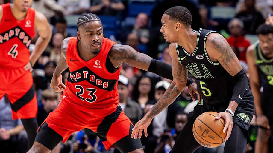New Orleans Pelicans guard Dejounte Murray dribbles against Toronto Raptors guard Jamal Shead