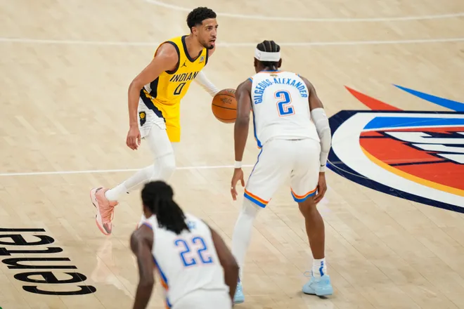 Jun 5, 2025; Oklahoma City, Oklahoma, USA; Indiana Pacers guard Tyrese Haliburton (0) dribbles the ball against Oklahoma City Thunder guard Shai Gilgeous-Alexander (2) during the third quarter in game one of the 2025 NBA Finals at Paycom Center. Mandatory Credit: Kyle Terada-Imagn Images