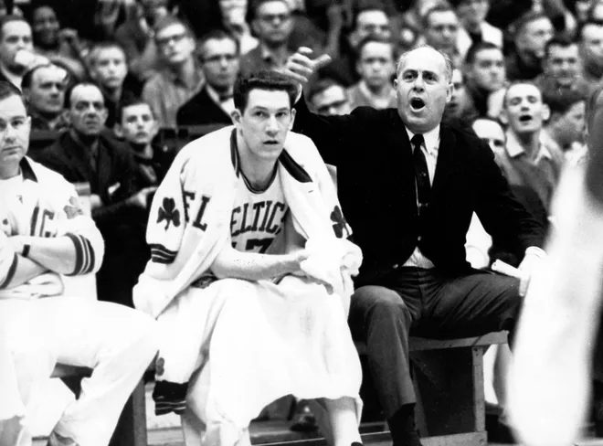 Unknown Date; Boston, MA, USA; FILE PHOTO; Boston Celtics former head coach Red Auerbach coacher next to former player John Havlicek and former trainer Buddy LeRoux during a game at the Boston Garden in Boston, MA. Mandatory Credit: Dick Raphael-USA TODAY Sports Copyright © Dick Raphael