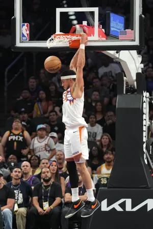 Phoenix Suns guard Devin Booker dunks.