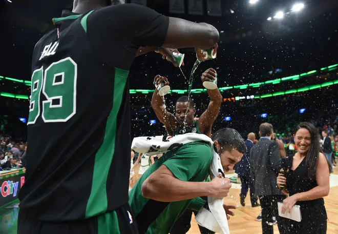 Dec 22, 2019; Boston, Massachusetts, USA; Boston Celtics center Tacko Fall (99) and guard Javonte Green (43) pour water on forward Jayson Tatum (0) after defeating the Charlotte Hornets at TD Garden. Mandatory Credit: Bob DeChiara-USA TODAY Sports