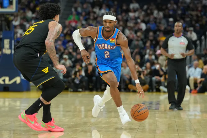 Jan 2, 2026; San Francisco, California, USA; Oklahoma City Thunder guard Shai Gilgeous-Alexander (2) dribbles against Golden State Warriors forward Gui Santos (15) during the third quarter at Chase Center. Mandatory Credit: Darren Yamashita-Imagn Images