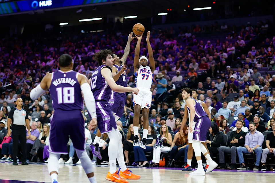 Mar 19, 2026; Sacramento, California, USA; Philadelphia 76ers guard Vj Edgecombe (77) scores against Sacramento Kings guard Malik Monk (0) during the second quarter at Golden 1 Center. Mandatory Credit: Sergio Estrada-Imagn Images