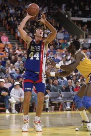 LOS ANGELES - 1990: Jack Haley #44 of the New Jersey Nets shoots the ball over Orlando Woolridge #0 of the Los Angeles Lakers during the NBA game at the Great Western Forum in Los Angeles, California in 1990. NOTE TO USER: User expressly acknowledges and agrees that, by downloading and/or using this Photograph, User is consenting to the terms and conditions of the Getty Images License Agreement. Mandatory copyright notice : Copyright 1990 NBAE. (Photo by Ken Levine /Getty Images)