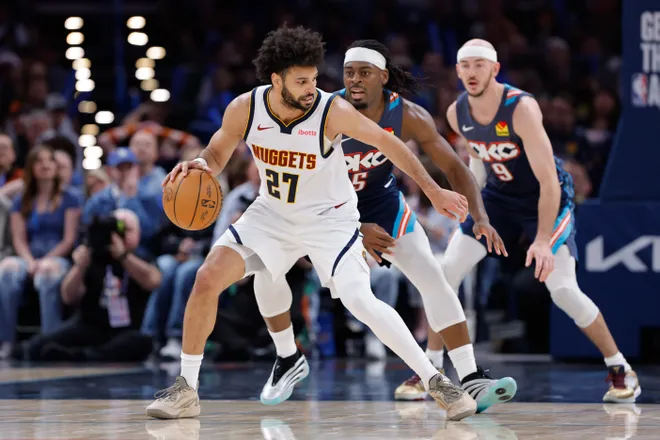 Feb 27, 2026; Oklahoma City, Oklahoma, USA; Denver Nuggets guard Jamal Murray (27) moves the ball around Oklahoma City Thunder guard Luguentz Dort (5) during the third quarter at Paycom Center. Mandatory Credit: Alonzo Adams-Imagn Images