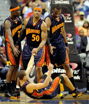 Apr 6, 2010; Washington, DC, USA; Golden State Warriors guard Stephen Curry (bottom) gets a hand from teammate Corey Maggette (50) during the first half against the Washington Wizards at the Verizon Center. Mandatory Credit: Rafael Suanes-USA TODAY Sports