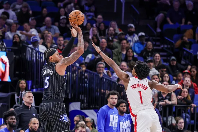 Feb 26, 2026; Orlando, Florida, USA; Orlando Magic forward Paolo Banchero (5) shoots against Houston Rockets guard Amen Thompson (1) during the second half at Kia Center.