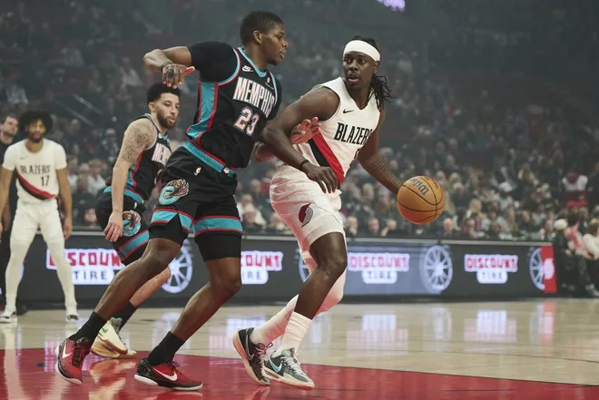Feb 6, 2026; Portland, Oregon, USA; Portland Trail Blazers guard Jrue Holiday (5) dribbles the ball during the first half against Memphis Grizzlies forward Cedric Coward (23) at Moda Center.