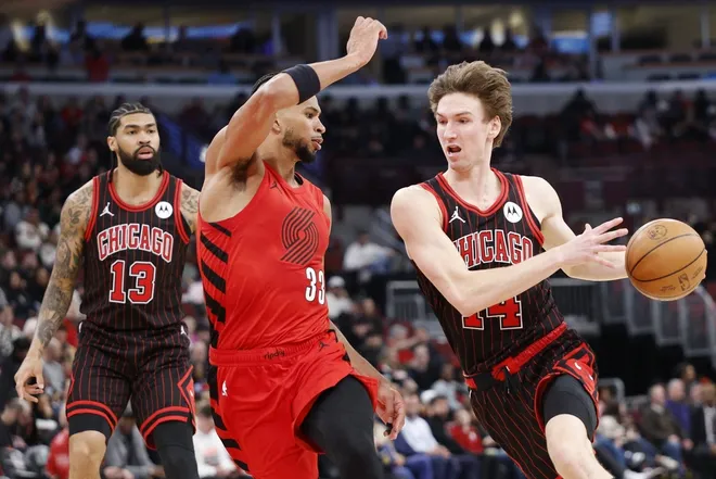 Feb 26, 2026; Chicago, Illinois, USA; Chicago Bulls forward Matas Buzelis (14) drives to the basket against Portland Trail Blazers forward Toumani Camara (33) during the first half of an NBA game at United Center.
