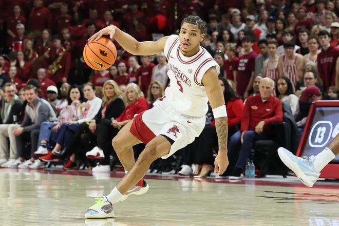 Feb 14, 2026; Fayetteville, Arkansas, USA; Arkansas Razorbacks guard Darius Acuff Jr (5) dribbles during the first half against the Auburn Tigers at Bud Walton Arena. Mandatory Credit: Nelson Chenault-Imagn Images