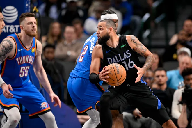 Mar 1, 2026; Dallas, Texas, USA; Dallas Mavericks forward Caleb Martin (16) looks to move the ball past Oklahoma City Thunder guard Shai Gilgeous-Alexander (2) and center Isaiah Hartenstein (55) during the second half at the American Airlines Center. Mandatory Credit: Jerome Miron-Imagn Images