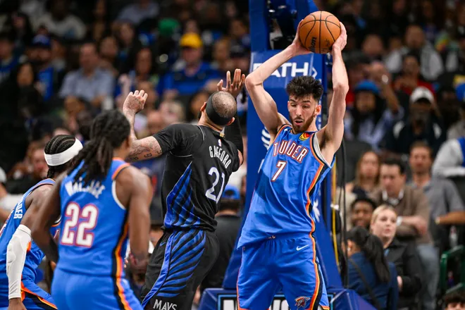 Mar 1, 2026; Dallas, Texas, USA; Oklahoma City Thunder center Chet Holmgren (7) grabs a rebound in front of Dallas Mavericks forward Daniel Gafford (21) during the second half at the American Airlines Center. Mandatory Credit: Jerome Miron-Imagn Images