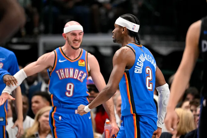Mar 1, 2026; Dallas, Texas, USA; Oklahoma City Thunder guard Alex Caruso (9) and guard Shai Gilgeous-Alexander (2) celebrate after Gilgeous-Alexander dunks the ball against the Dallas Mavericks during the second quarter at the American Airlines Center. Mandatory Credit: Jerome Miron-Imagn Images