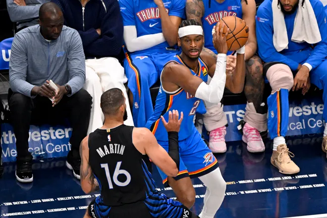 Mar 1, 2026; Dallas, Texas, USA; Oklahoma City Thunder guard Shai Gilgeous-Alexander (2) looks to move the ball past Dallas Mavericks forward Caleb Martin (16) during the first quarter at the American Airlines Center. Mandatory Credit: Jerome Miron-Imagn Images