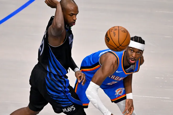 Mar 1, 2026; Dallas, Texas, USA; Dallas Mavericks forward Khris Middleton (20) and Oklahoma City Thunder guard Shai Gilgeous-Alexander (2) battle for the loose ball during the first quarter at the American Airlines Center. Mandatory Credit: Jerome Miron-Imagn Images