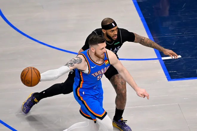 Mar 1, 2026; Dallas, Texas, USA; Oklahoma City Thunder center Isaiah Hartenstein (55) looks to move the ball past Dallas Mavericks forward Daniel Gafford (21) during the first quarter at the American Airlines Center. Mandatory Credit: Jerome Miron-Imagn Images