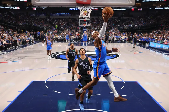 DALLAS, TEXAS - MARCH 01: Shai Gilgeous-Alexander #2 of the Oklahoma City Thunder makes a move to the basket past Max Christie #00 of the Dallas Mavericks during the first quarter at American Airlines Center on March 01, 2026 in Dallas, Texas. NOTE TO USER: User expressly acknowledges and agrees that, by downloading and or using this photograph, user is consenting to the terms and conditions of the Getty Images License Agreement. (Photo by Sam Hodde/Getty Images)