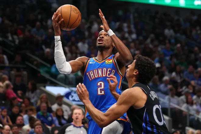 DALLAS, TEXAS - MARCH 01: Shai Gilgeous-Alexander #2 of the Oklahoma City Thunder goes to the basket against Max Christie #00 of the Dallas Mavericks during the third quarter at American Airlines Center on March 01, 2026 in Dallas, Texas. NOTE TO USER: User expressly acknowledges and agrees that, by downloading and or using this photograph, user is consenting to the terms and conditions of the Getty Images License Agreement. (Photo by Sam Hodde/Getty Images)