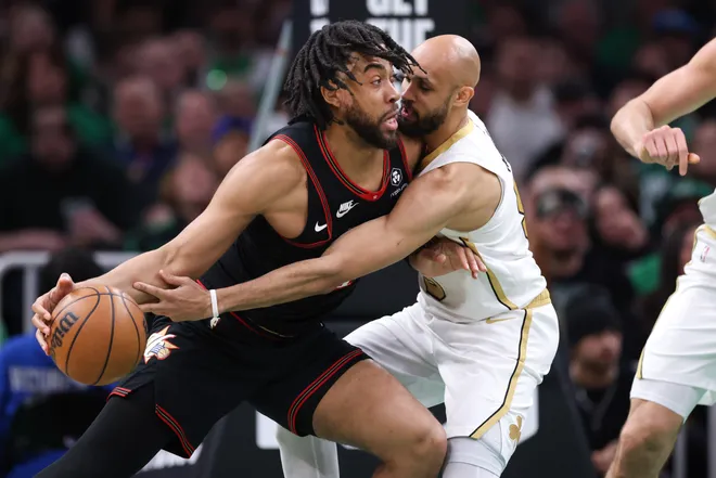 Mar 1, 2026; Boston, Massachusetts, USA; Boston Celtics guard Derrick White (9) defends Philadelphia 76ers forward Trendon Watford (12) during the second half at TD Garden. Mandatory Credit: Paul Rutherford-Imagn Images