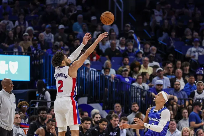 Mar 1, 2026; Orlando, Florida, USA; Detroit Pistons guard Cade Cunningham (2) shoots a three-point basket over Orlando Magic guard Jalen Suggs (4) during the second half at Kia Center.