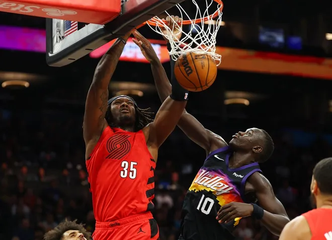Feb 22, 2026; Phoenix, Arizona, USA; Portland Trail Blazers center Robert Williams III (35) dunks the ball against Phoenix Suns center Khaman Maluach (10) in the second half at Mortgage Matchup Center.