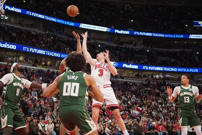 Mar 1, 2026; Chicago, Illinois, USA; Chicago Bulls guard Josh Giddey (3) shoots the ball over Milwaukee Bucks center Jericho Sims (00) during the first half at United Center.