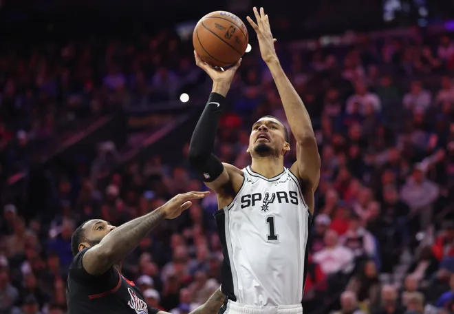 Mar 3, 2026; Philadelphia, Pennsylvania, USA; San Antonio Spurs forward Victor Wembanyama (1) shoots in front of Philadelphia 76ers center Andre Drummond (1) during the second quarter at Xfinity Mobile Arena. Mandatory Credit: Bill Streicher-Imagn Images