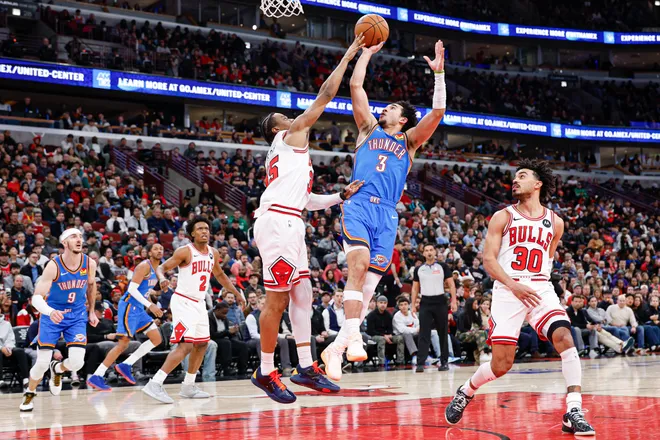 Mar 3, 2026; Chicago, Illinois, USA; Oklahoma City Thunder guard Jared McCain (3) shoots against Chicago Bulls forward Isaac Okoro (35) during the second half at United Center. Mandatory Credit: Kamil Krzaczynski-Imagn Images