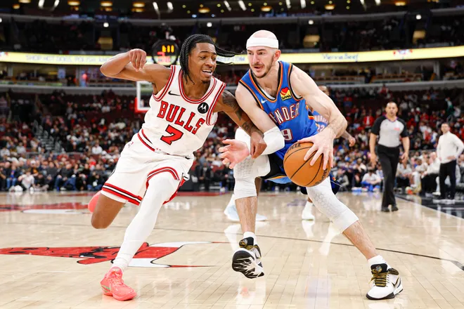 Mar 3, 2026; Chicago, Illinois, USA; Chicago Bulls guard Rob
Dillingham (7) defends against Oklahoma City Thunder guard Alex Caruso (9) during the second half at United Center. Mandatory Credit: Kamil Krzaczynski-Imagn Images