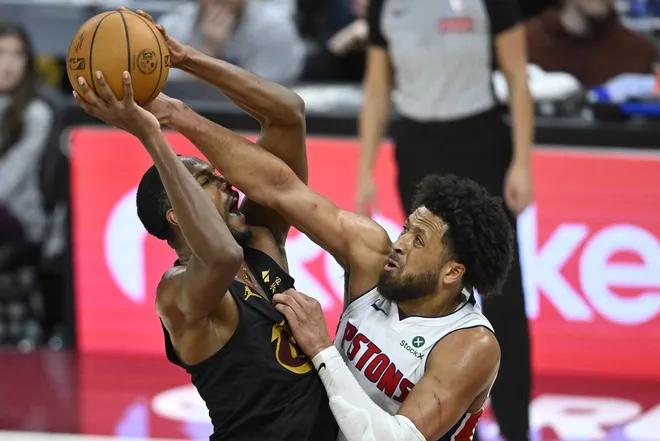 Mar 3, 2026; Cleveland, Ohio, USA; Cleveland Cavaliers center Evan Mobley (4) shoots beside Detroit Pistons guard Cade Cunningham (2) in the fourth quarter at Rocket Arena.