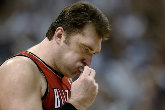Arvydas Sabonis of the Portland Trail Blazers removes his mouth guard.