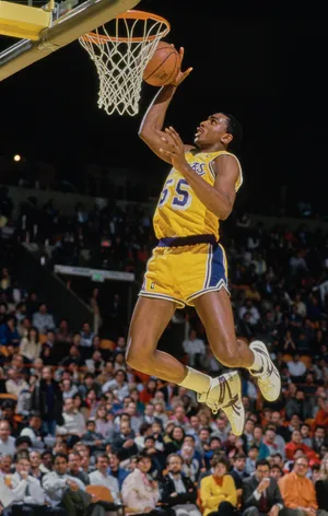 Billy Thompson jumps to make a slam dunk.