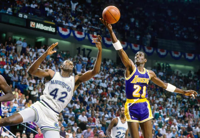 Los Angeles Lakers forward Michael Cooper shoots over Dallas Mavericks forward Roy Tarpley.