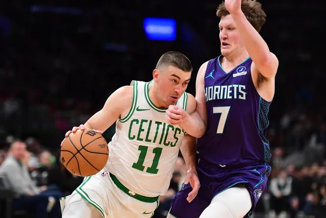 Mar 4, 2026; Boston, Massachusetts, USA; Boston Celtics guard Payton Pritchard (11) drives to the basket while Charlotte Hornets guard Kon Knueppel (7) defends during the first half at TD Garden.