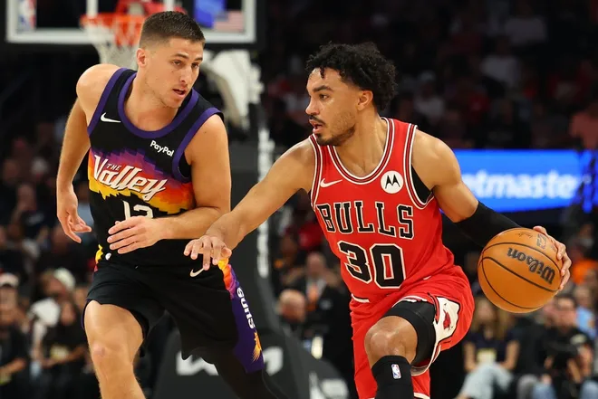 Mar 5, 2026; Phoenix, Arizona, USA; Chicago Bulls guard Tre Jones (30) dribbles down court against Phoenix Suns guard Collin Gillespie (12) in the second quarter at Mortgage Matchup Center.