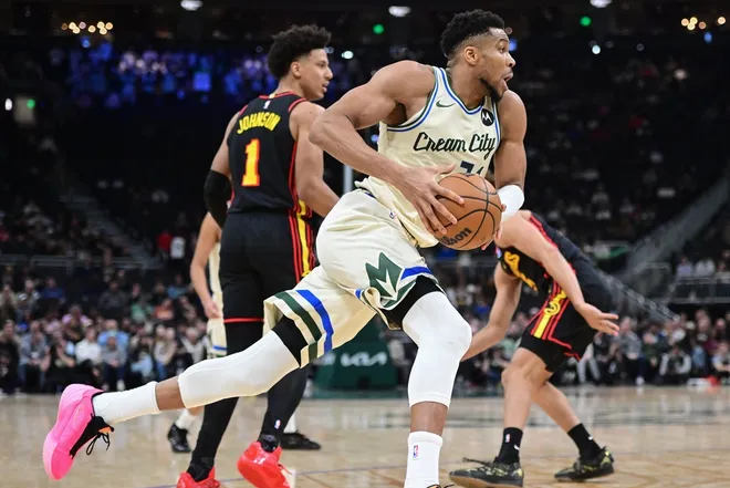 Mar 4, 2026; Milwaukee, Wisconsin, USA; Milwaukee Bucks forward Giannis Antetokounmpo (34) drives for the basket past Atlanta Hawks forward Jalen Johnson (1) in the second quarter at Fiserv Forum.