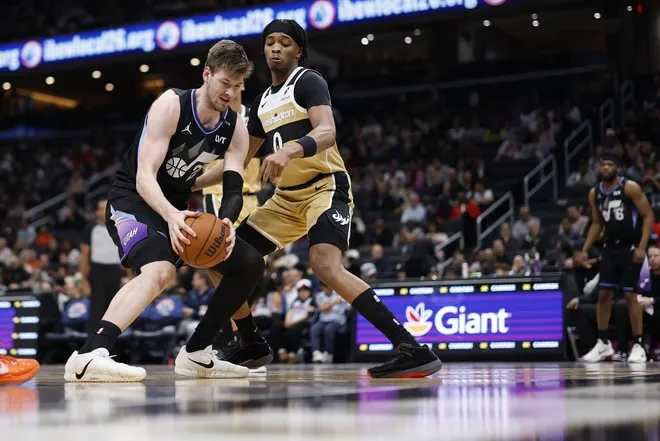 Mar 5, 2026; Washington, District of Columbia, USA; Utah Jazz forward Kyle Filipowski (22) drives to the basket as Washington Wizards guard Bilal Coulibaly (0) defends in the second half at Capital One Arena.