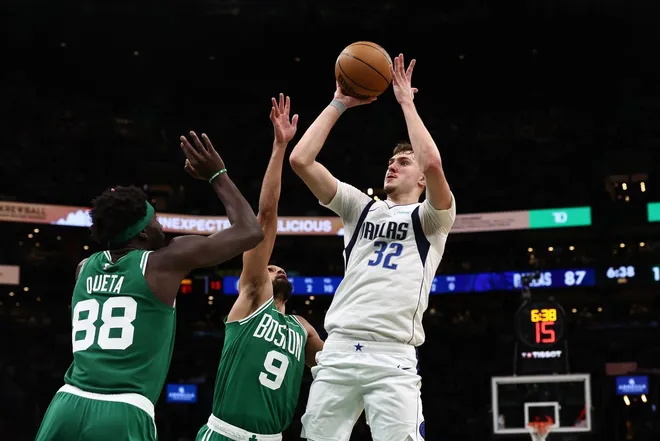 Mar 6, 2026; Boston, Massachusetts, USA; Dallas Mavericks forward Cooper Flagg (32) shoots over Boston Celtics guard Derrick White (9) and center Neemias Queta (88) during the second half at TD Garden.